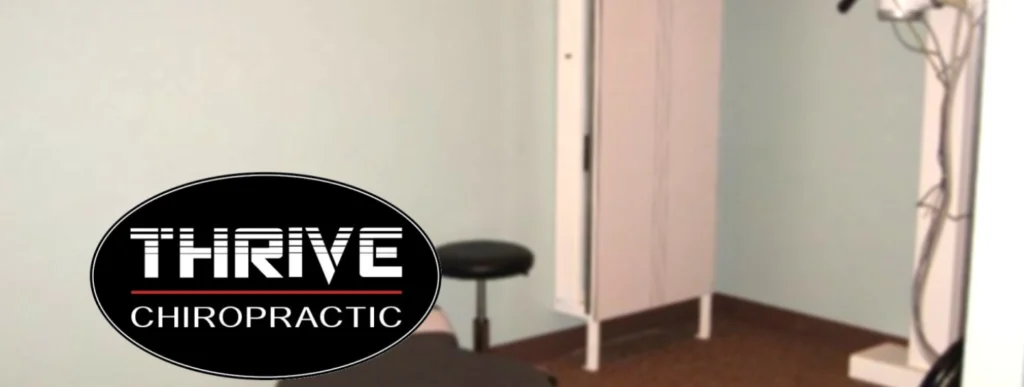 A room with a black stool and white walls