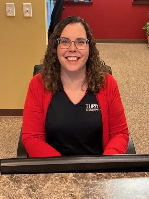 A woman sitting in front of a keyboard.